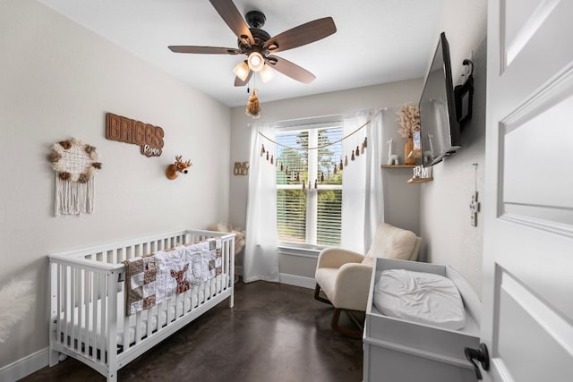 102 Moku Ct, Bastrop, TX 78602 - bedroom featuring finished concrete flooring, a crib, and a ceiling fan
