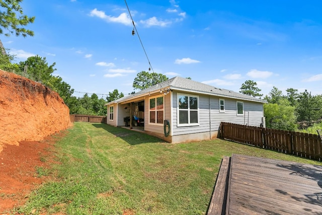 102 Moku Ct, Bastrop, TX 78602 - rear view of house featuring a fenced backyard and a wooden deck