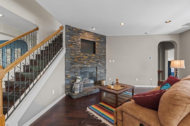 2611 Terlingua Dr, Cedar Park, TX 78613 - living area featuring hardwood / wood-style floors, arched walkways, recessed lighting, a stone fireplace, and stairway