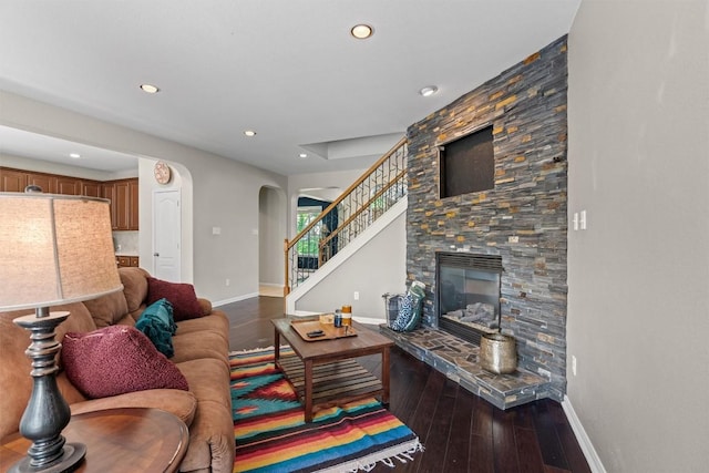 2611 Terlingua Dr, Cedar Park, TX 78613 - living room featuring arched walkways, hardwood / wood-style flooring, recessed lighting, stairway, and a stone fireplace