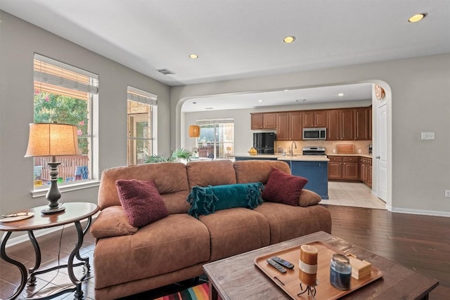 2611 Terlingua Dr, Cedar Park, TX 78613 - living room featuring recessed lighting, light wood finished floors, and arched walkways