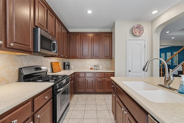 2611 Terlingua Dr, Cedar Park, TX 78613 - kitchen with stainless steel appliances, light countertops, light tile patterned floors, recessed lighting, and decorative backsplash