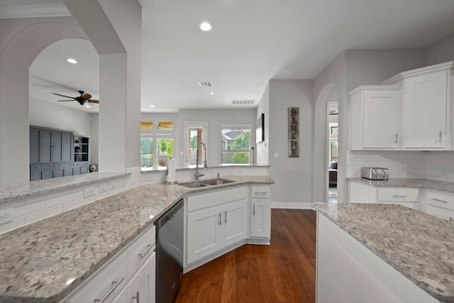 113 Swallowtail Dr, Austin, TX 78737 - kitchen with stainless steel dishwasher, arched walkways, dark wood-style flooring, white cabinets, and recessed lighting