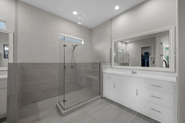 113 Swallowtail Dr, Austin, TX 78737 - bathroom featuring tiled shower, vanity, tile patterned floors, a spacious closet, and recessed lighting