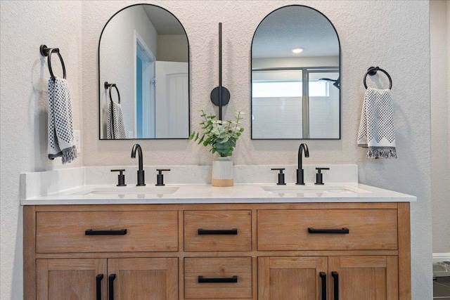 200 Mais Dr, Georgetown, TX 78626 - bathroom featuring a textured wall and double vanity