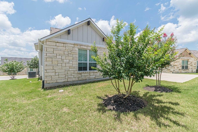 116 Mulligan Dr Unit 103, San Marcos, TX 78666 - view of home's exterior featuring board and batten siding, stone siding, and a yard
