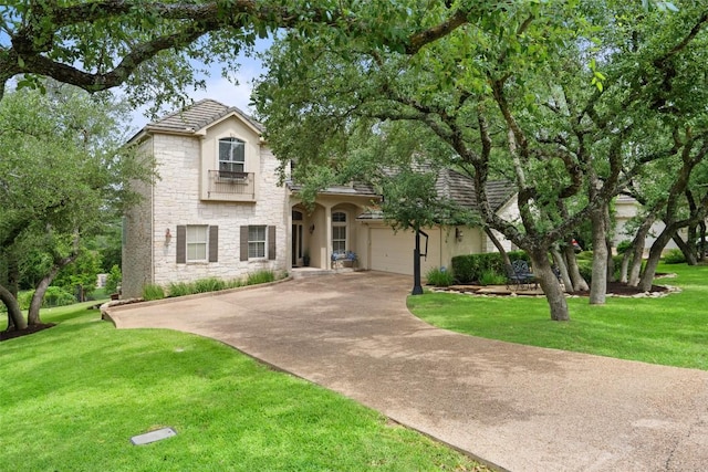 25 Falling Oaks Trl, The Hills, TX 78738 - view of front of property featuring stone siding, driveway, a front lawn, and stucco siding