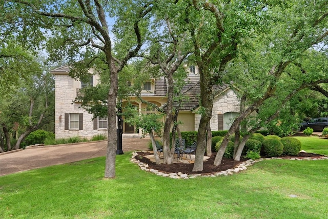 25 Falling Oaks Trl, The Hills, TX 78738 - view of property hidden behind natural elements featuring stone siding and a front lawn
