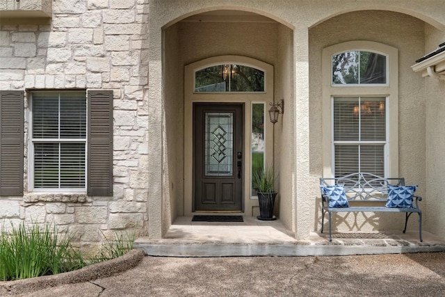 25 Falling Oaks Trl, The Hills, TX 78738 - view of exterior entry with stone siding and stucco siding