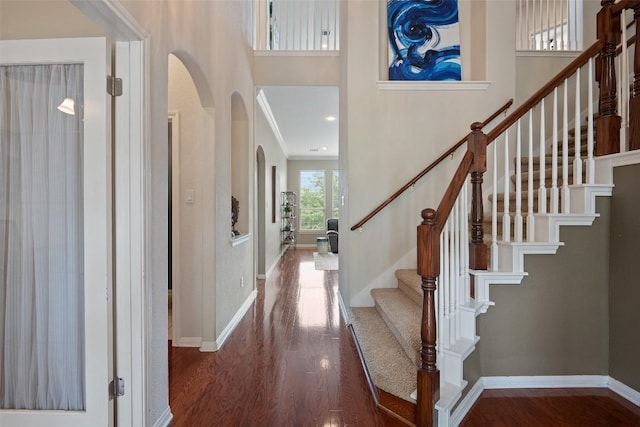 25 Falling Oaks Trl, The Hills, TX 78738 - foyer entrance featuring arched walkways, wood finished floors, stairway, and a high ceiling