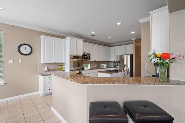 25 Falling Oaks Trl, The Hills, TX 78738 - kitchen featuring appliances with stainless steel finishes, tasteful backsplash, crown molding, a peninsula, and white cabinets