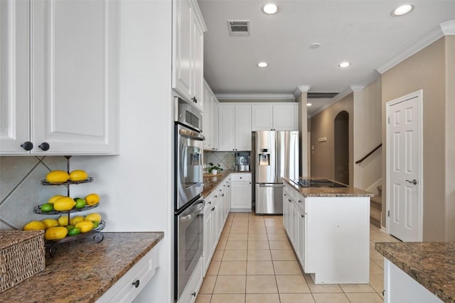 25 Falling Oaks Trl, The Hills, TX 78738 - kitchen featuring appliances with stainless steel finishes, tasteful backsplash, crown molding, white cabinetry, and light tile patterned flooring