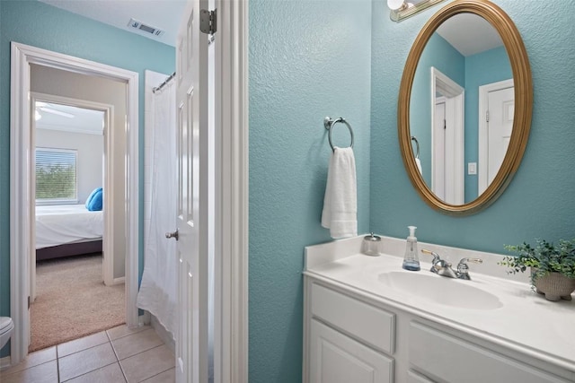 25 Falling Oaks Trl, The Hills, TX 78738 - bathroom with vanity, tile patterned flooring, ensuite bathroom, a textured wall, and a shower with shower curtain