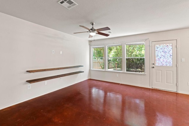 4608 Acers Ln, Austin, TX 78725 - unfurnished living room featuring concrete floors, a ceiling fan, and a textured ceiling