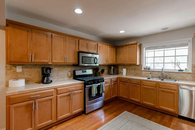 6612 Ashland Dr, Austin, TX 78723 - kitchen with stainless steel appliances, dark wood-style flooring, tasteful backsplash, recessed lighting, and tile countertops