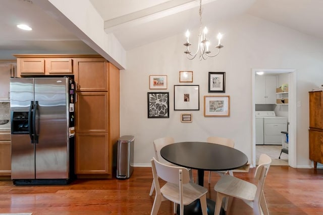 6612 Ashland Dr, Austin, TX 78723 - dining space with independent washer and dryer, light wood-style floors, a chandelier, and vaulted ceiling