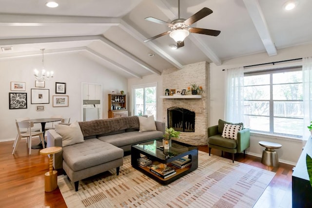 6612 Ashland Dr, Austin, TX 78723 - living room with wood finished floors, ceiling fan, a chandelier, and a stone fireplace