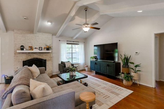 6612 Ashland Dr, Austin, TX 78723 - living room featuring wood finished floors, ceiling fan, and a stone fireplace