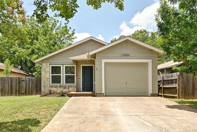 9710 Curlew Dr, Austin, TX 78748 - view of front of home featuring driveway, a garage, and stone siding