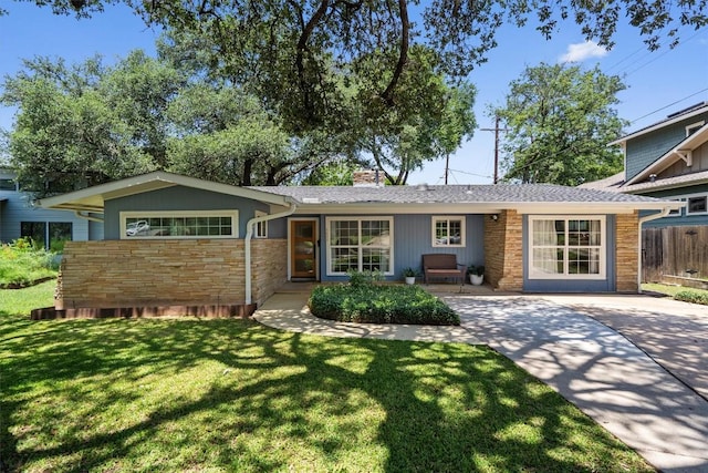 4604 Rue St, Austin, TX 78731 - view of front of home with stone siding, a chimney, and driveway