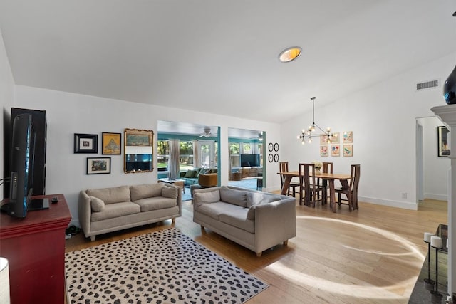 4604 Rue St, Austin, TX 78731 - living room featuring vaulted ceiling, light wood-style flooring, and a chandelier
