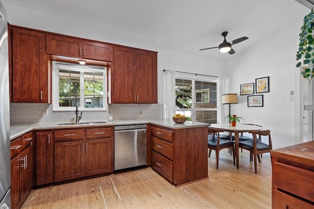 4604 Rue St, Austin, TX 78731 - kitchen with dishwasher, a peninsula, backsplash, and light wood-style floors