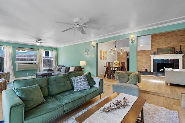 4604 Rue St, Austin, TX 78731 - living area with ceiling fan, a chandelier, wood finished floors, a tile fireplace, and cooling unit