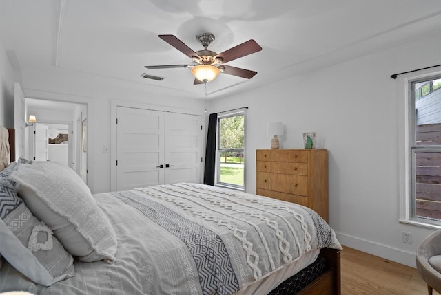 4604 Rue St, Austin, TX 78731 - bedroom featuring wood finished floors, multiple windows, a closet, and ceiling fan