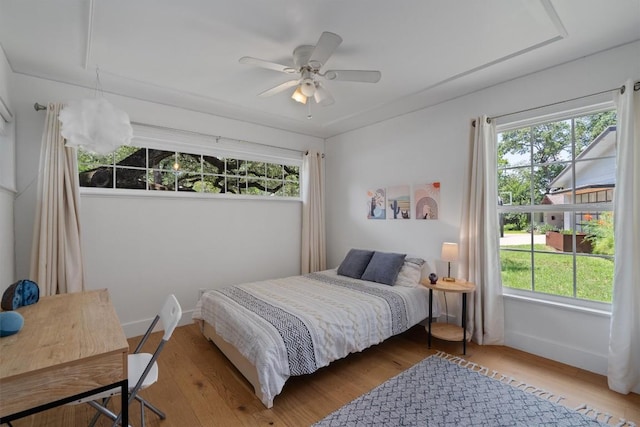 4604 Rue St, Austin, TX 78731 - bedroom with multiple windows, wood finished floors, and ceiling fan