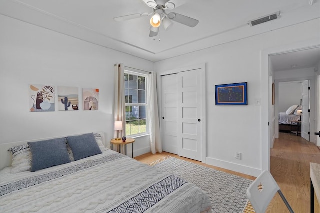 4604 Rue St, Austin, TX 78731 - bedroom with wood finished floors, a closet, and a ceiling fan