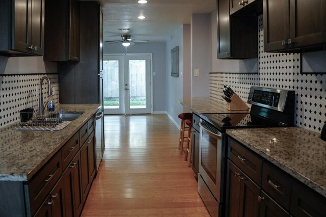 22631 John Rolfe Ln, Katy, TX 77449 - kitchen featuring stainless steel appliances, backsplash, light wood-style floors, a ceiling fan, and dark brown cabinetry