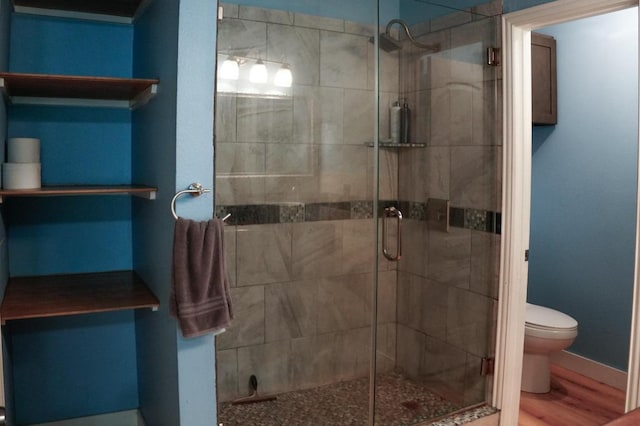 22631 John Rolfe Ln, Katy, TX 77449 - bathroom featuring a shower stall and wood finished floors