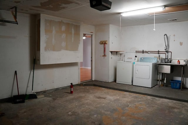 22631 John Rolfe Ln, Katy, TX 77449 - garage featuring washer and clothes dryer and a garage door opener