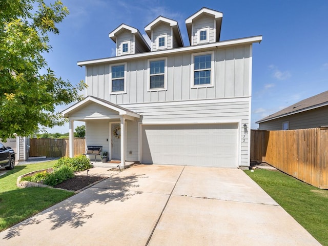 752 Circle Way Unit 35H, Jarrell, TX 76537 - view of front facade with board and batten siding, a garage, and concrete driveway