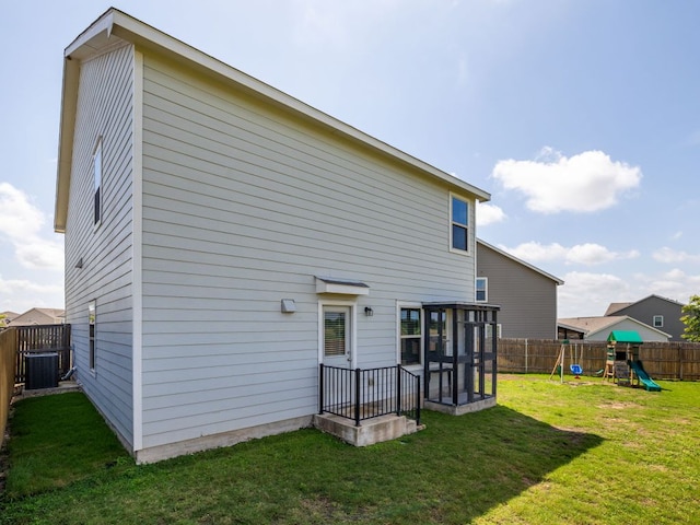 752 Circle Way Unit 35H, Jarrell, TX 76537 - back of property with a playground, a fenced backyard, and a sunroom