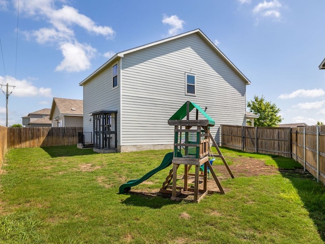 752 Circle Way Unit 35H, Jarrell, TX 76537 - rear view of house with a fenced backyard and a playground