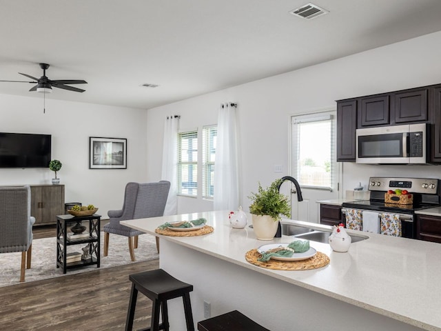 752 Circle Way Unit 35H, Jarrell, TX 76537 - kitchen featuring appliances with stainless steel finishes, healthy amount of natural light, open floor plan, and dark wood-type flooring