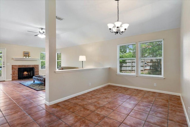 1601 Muledeer Run, Leander, TX 78641 - tiled spare room featuring a ceiling fan, a chandelier, a tiled fireplace, and vaulted ceiling