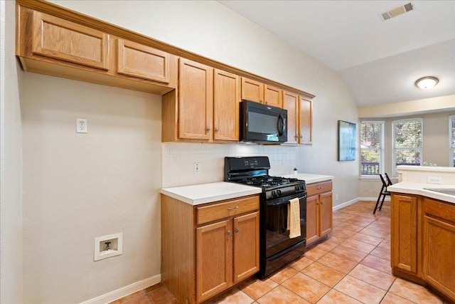 1601 Muledeer Run, Leander, TX 78641 - kitchen featuring black appliances, decorative backsplash, vaulted ceiling, light countertops, and light tile patterned flooring