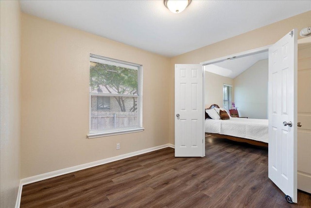 1601 Muledeer Run, Leander, TX 78641 - bedroom with lofted ceiling, multiple windows, and dark wood-style floors