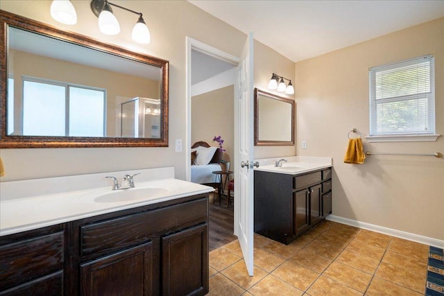 1601 Muledeer Run, Leander, TX 78641 - full bath with plenty of natural light, two vanities, tile patterned flooring, and a shower with door
