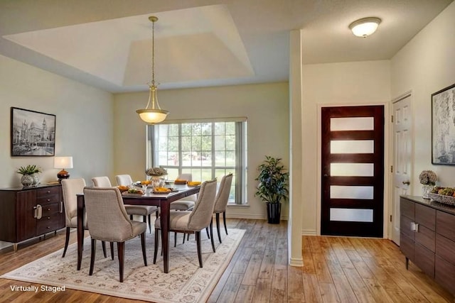 128 Moku Manu Dr, Bastrop, TX 78602 - dining room with light wood-style floors and a tray ceiling