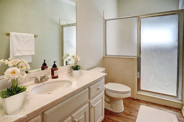 128 Moku Manu Dr, Bastrop, TX 78602 - bathroom with vanity, wood finished floors, and a shower with door