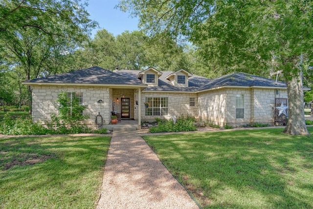 128 Moku Manu Dr, Bastrop, TX 78602 - view of front of property with a front lawn and stone siding