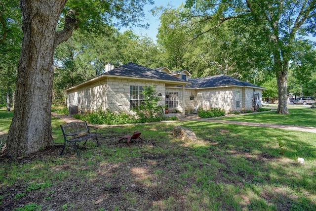 128 Moku Manu Dr, Bastrop, TX 78602 - single story home featuring a chimney and a front lawn