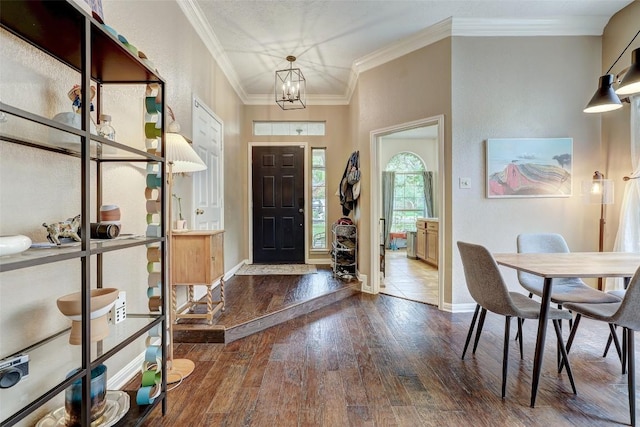 5907 Shanghai Pierce Rd, Austin, TX 78749 - foyer with wood-type flooring, ornamental molding, and a chandelier