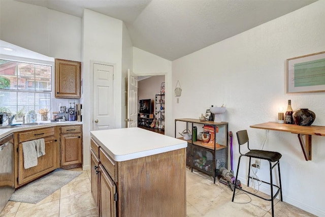 5907 Shanghai Pierce Rd, Austin, TX 78749 - kitchen with lofted ceiling, brown cabinets, a kitchen island, and light countertops