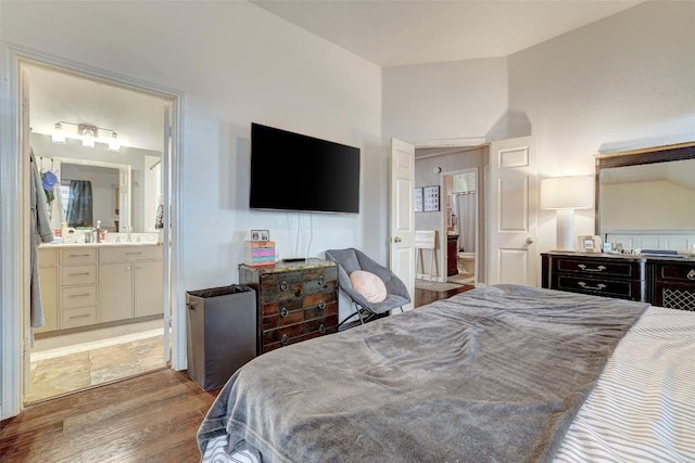 5907 Shanghai Pierce Rd, Austin, TX 78749 - bedroom with wood finished floors, vaulted ceiling, and ensuite bath