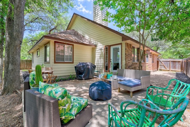 5907 Shanghai Pierce Rd, Austin, TX 78749 - rear view of property featuring an outdoor living space, a chimney, a fenced backyard, and brick siding