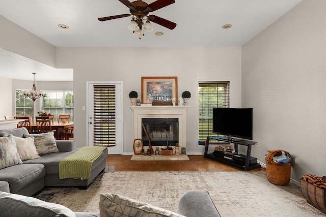 251 Barton Meadow Dr, Dripping Springs, TX 78620 - living room with ceiling fan, a glass covered fireplace, a chandelier, and recessed lighting